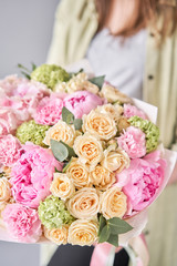 Pink peonies and hydrangea. Beautiful bouquet of mixed flowers in woman hand. Floral shop concept . Handsome fresh bouquet. Flowers delivery.