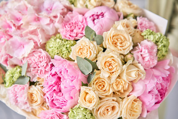 closeup Pink peonies and hydrangea. Beautiful bouquet of mixed flowers in woman hand. Floral shop concept . Handsome fresh bouquet. Flowers delivery.