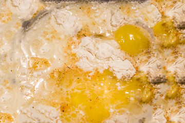 preparing dough and whisking flour and eggs. Ingredients for cooking cake (flour, egg, milk) on dark table. The concept of making dough for baking
