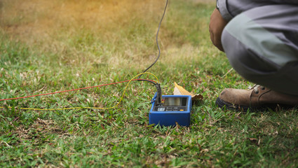 close up engineer hand use electrical equipment ground resistance tester for protect electric system