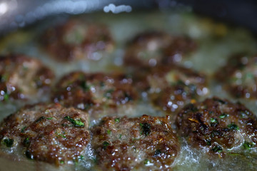 cooking meatballs in a pan and oil