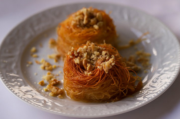 Turkish style kadayif dessert in white plate