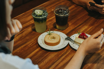 Young woman eating dessert, Close-up of female's hand using fork to get piece of cake.