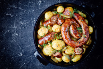 Baking dish with potato and round italian sausage