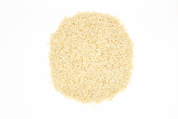 A pile of long-grain, brown rice on a white background. Top view with space for the label.