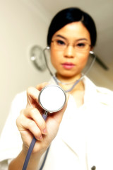 Female doctor placing her stethoscope near to the camera