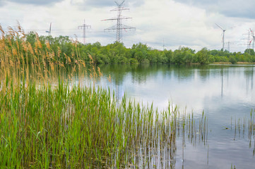 View of a quarry pond from the shore with  overcast skies and calm water in northern Germany