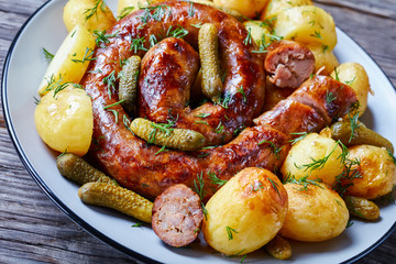 Warm young potato dish with gherkins and sausage