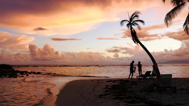 Couple enjoying life on the beach during sunset at the seashore in Guadeloupe