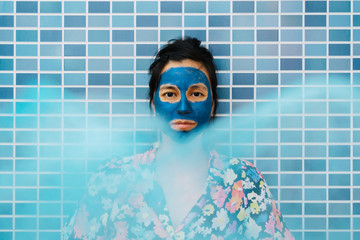 Woman with a beauty mask in the shower