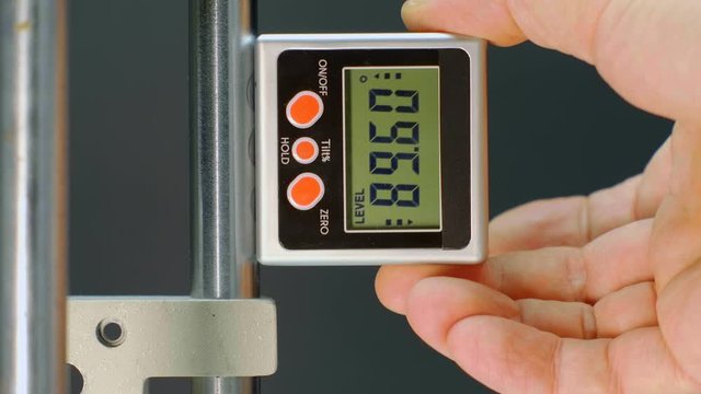 The modern device, which is very necessary in construction and repair - digital magnetic goniometer - measuring the angle of an inclined surface. Macro. Closeup