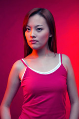 Woman in red top posing on a red background