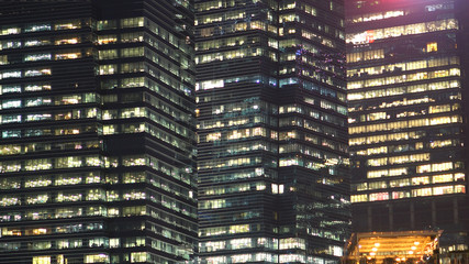Modern Office Skyscraper Buildings and Glass Windows at Night