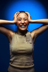 Fototapeta premium Depressed woman pressing her head with her hands