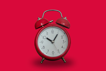 Red alarm clock on a red background