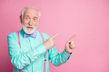 Photo of cool stylish look aged man guy open mouth indicating fingers empty space black friday low prices wear mint shirt suspenders bow tie isolated pastel pink color background