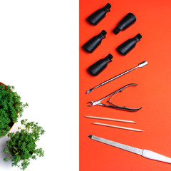 Top view of equipment for manicure and pedicure on a orange background. Tongs, nail file, pusher....