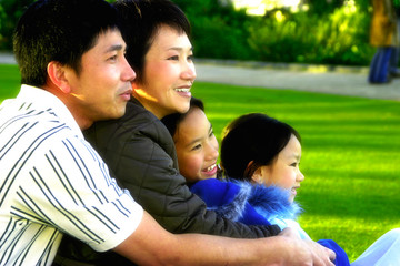 Side shot of a family resting in a park