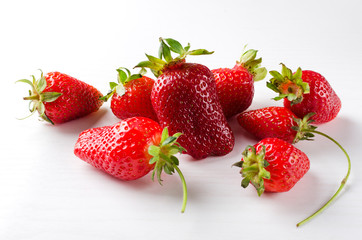 Closeup of group of fresh juicy strawberries on the white background.Natiral and organic fruits