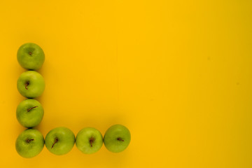 many apples on yellow background