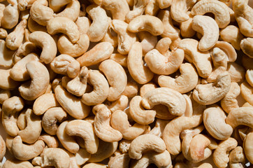 Tasty cashew nuts as background, top view