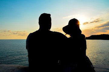 Portrait of a happy couple observing the sunset