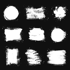 Paint brush stains. Vector grunge shapes isolated on black backgrounds.