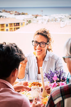 Happy Family Meeting At Lunch With Parents And Friends After Lockdown Coronavirus Health Emergency - Cheerful People Together Eating And Drinking At Home With City And Ocean View