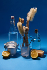 natural cleaning stuff, sustainability and eco living concept - lemon halves, washing soda, bottle...