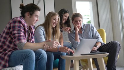 group of young people working on a laptop - Powered by Adobe