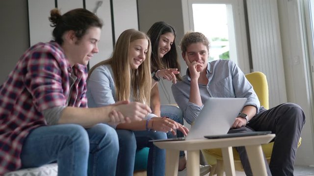 group of young people working on a laptop