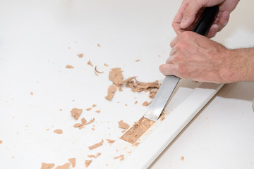 Installation of a hinge for an interior door. Chisel work.