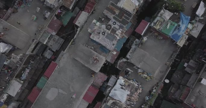 Ungraded, Bird's eye view, ascending aerial flight over poor housing area. Drone, 4K. 