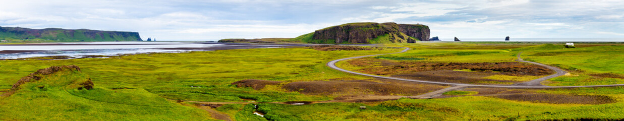 Extra long panorama of Dyrholaey bay skyline in Iceland during summer time. Dyrholaey is Unique peninsula in Iceland known for scenic view. 