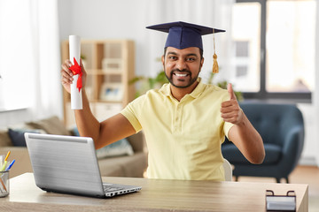 e-learning, education and people concept - happy smiling indian male graduate student with laptop...