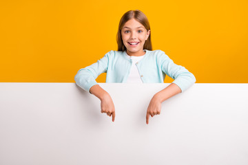Photo of beautiful pretty little small lady directing fingers down big empty space white placard...