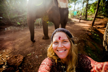 beautiful girl next to an elephant - 351182097