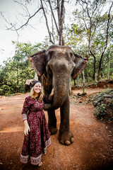 beautiful girl next to an elephant - 351182282