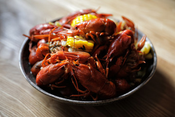 boiled crawfish with corn on the plate. seafood.
