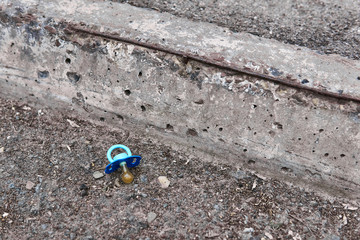 lost pacifier lies on the side of the road