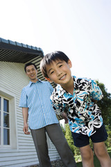 Father and son smiling at the camera