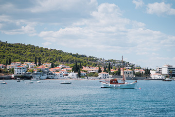 Fototapeta na wymiar Spetses Island coast in Greece. A famous tourist destination on the Aegean sea. Old town and harbour view.