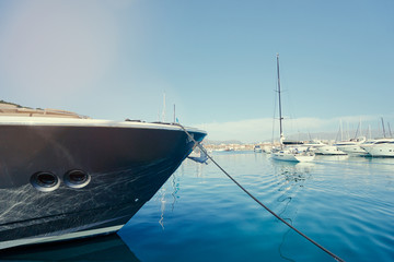 The bow of big yacht moored at marina.