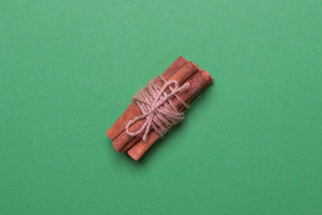 cinnamon sticks on black colored paper background, top view