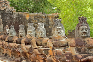 Stone statues of Asuras at the south gate of Angkor Thom, Angkor Wat. Overlooking the Moat