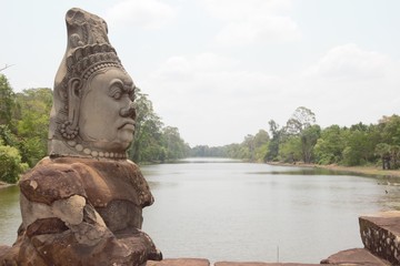 Stone statue of Asura at the south gate of Angkor Thom, Angkor Wat. Overlooking the Moat