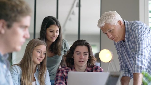 group of students working with a teacher