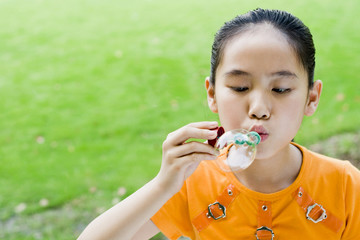 Girl playing with soap bubble