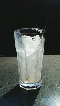 Empty Milk Glass On Tiled Floor