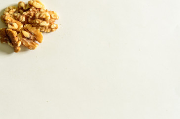 Group of peeled walnuts on the top left on white background. Healthy Food For The Heart.